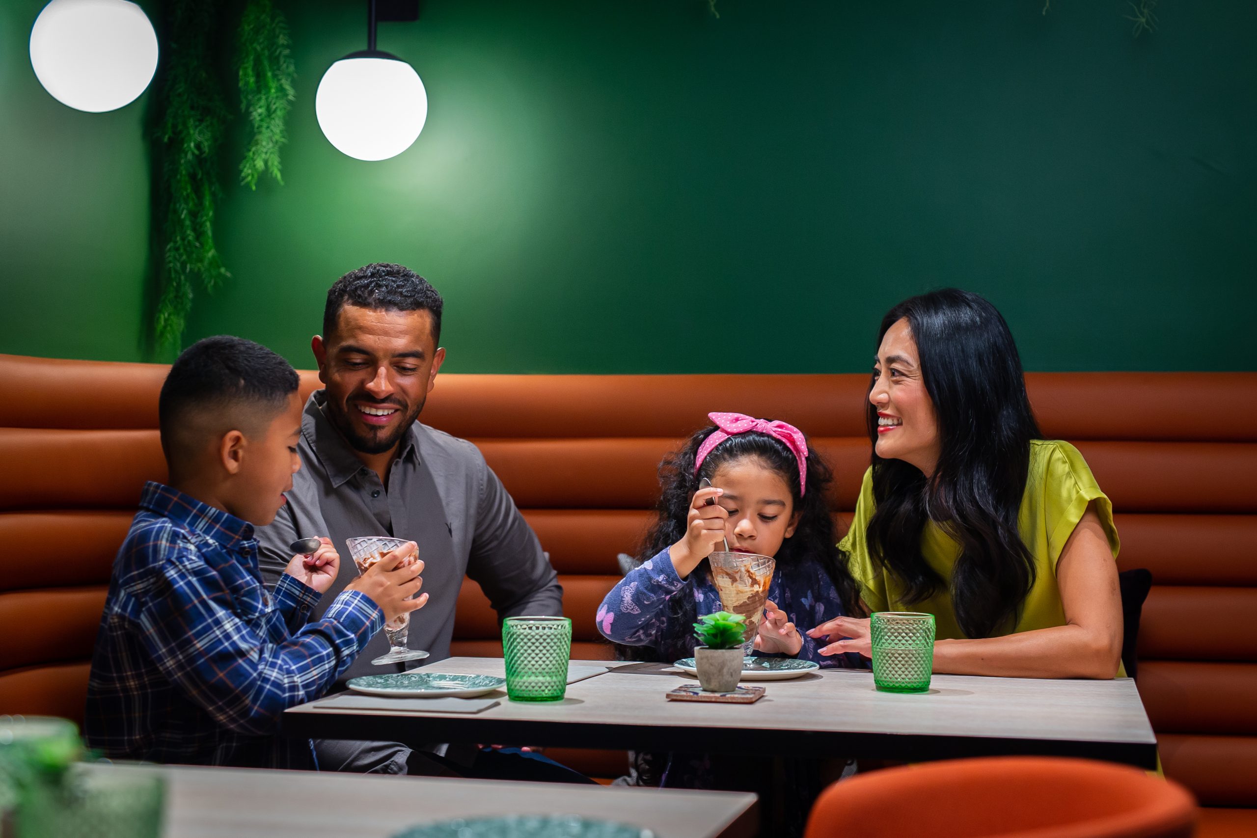 family eating ice cream in restaurant